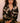 Model wearing the Olivia von Halle Lila Rene Black Blossom silk pajama set featuring the exclusive Blossom floral print on black silk satin with ivory contrast piping.