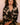 Model wearing the Olivia von Halle Lila Rene Black Blossom silk pajama set featuring the exclusive Blossom floral print on black silk satin with ivory contrast piping.