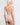 Back view of model wearing Oscalito wool and silk V-neck camisole in beige with satin trim highlighting seamless construction.