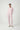 Woman wearing the Pluto Aadia Abelone Pajama Set in soft pink featuring a long sleeve crew neck top and tapered cotton modal pajama pants.