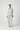 Woman wearing the Pluto Abbey Adalia Pajama Set in light gray featuring a button-down shirt and wide-leg cotton modal pajama pants.