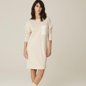 Model wearing Pluto Ebba Cotton Gown in ivory showing long sleeves and lace pocket detail