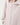 Close-up of dusty pink cotton gown button placket and beaded pocket trim