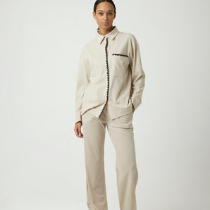 Beige cotton pajama set with black piping and zigzag pocket trim