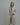 Model wearing the pluto priska robe in beige with black trim, shawl collar, and tie waist