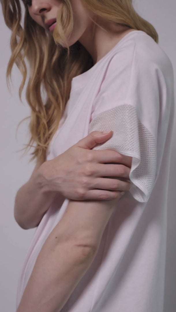 video of model wearing the Larysa knitted cotton gown by Pluto with a relaxed t-shirt fit and short sleeves