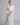 video of Model wearing Pluto Sylvie long robe in ivory with wrap design, matelassé fabric and belt