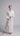 video of Model wearing Pluto Sylvie long robe in ivory with wrap design, matelassé fabric and belt