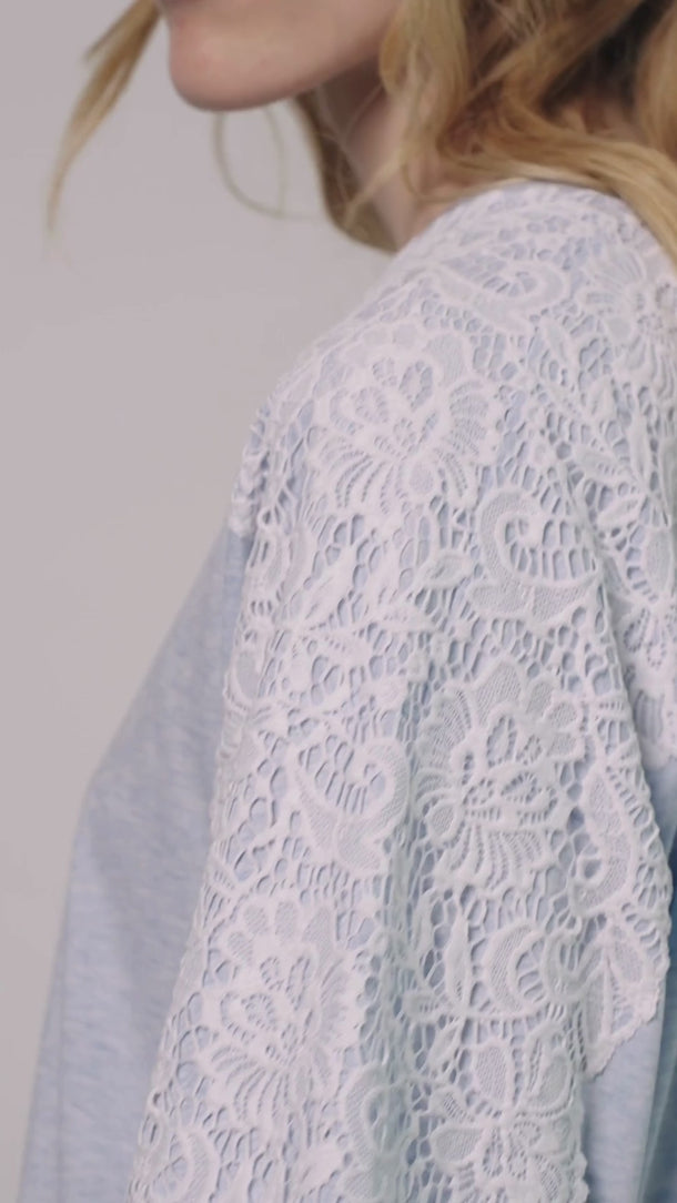 video of model wearing the Caite cotton gown in blue by Pluto with a crew neckline, relaxed fit and floral lace-style detailing