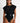 Model wearing SHAN Maeva One Piece Swimsuit with mosaic cutouts, flared sleeves, and silver belt