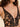 Close-up of black embroidered tulle plunging underwire cup with scalloped lace edge and sheer center panel