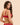 Back view of model wearing the Simone Pérèle Intrigue sheer embroidered demi cup bra in opera red featuring adjustable straps and a sheer tulle back band.