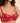 Model wearing the Simone Pérèle Intrigue sheer embroidered demi cup bra in opera red with floral embroidery, unlined tulle cups, and underwire support.
