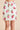 Short silk pajama set in strawberry print with elastic waist shorts and branded buttons, offering breezy fit and charming luxury.