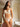 model wearing the Sublime Organza thong in white by Lise Charmel with embroidered organza front and lace sides