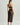 Woman wearing Tokyo Evenings black lace skirt with matching bralette, back view
