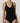 Close-up of black forming bodysuit showing molded bust and V-neckline