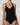 Close-up of black forming bodysuit showing molded bust and V-neckline