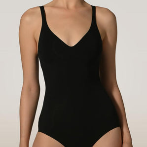Close-up of black forming bodysuit showing molded bust and V-neckline