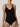 Close-up of black forming bodysuit showing molded bust and V-neckline