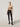 Model wearing Wolford Cotton Dot Tights in black showing all-over dot pattern and smooth matt finish, combined with beige top