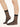Model wearing Wolford Individual 10 Socks in black showing sheer matte finish and smooth cuff