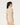 Back view of the Wolford Infinite Rose Net String Body in cream, showcasing the seamless floral net construction, sleeveless silhouette, thong back, and fitted design.