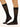 Model wearing Wolford Pure Energy 30 Leg Vitalizer Knee-Highs in black showing semi-transparent gloss and soft comfort band