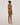 Back view of the Wolford Pure String in Fairly Light showcasing a seamless thong silhouette with a smooth invisible finish.