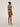 Back view of the Wolford Pure String in Fairly Light showcasing a seamless thong silhouette with a smooth invisible finish.