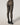 Back view of model wearing Wolford Reptile Net Tights in black showing seamless fit and waistband logo detail