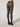 Back view of model wearing Wolford Reptile Net Tights in black showing seamless fit and waistband logo detail