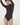 Model wearing Wolford Seamless Wool String Body in Dark Wood showing turtleneck and smooth seamless fit