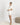 Jolene Ivory pajama set with black ruffled piping, short-sleeve top, and mid-rise longer shorts in breathable bamboo fabric.