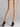 Back view of model wearing Wolford Individual 10 Back Seam Tights in gobi showing classic black back seam and waistband logo